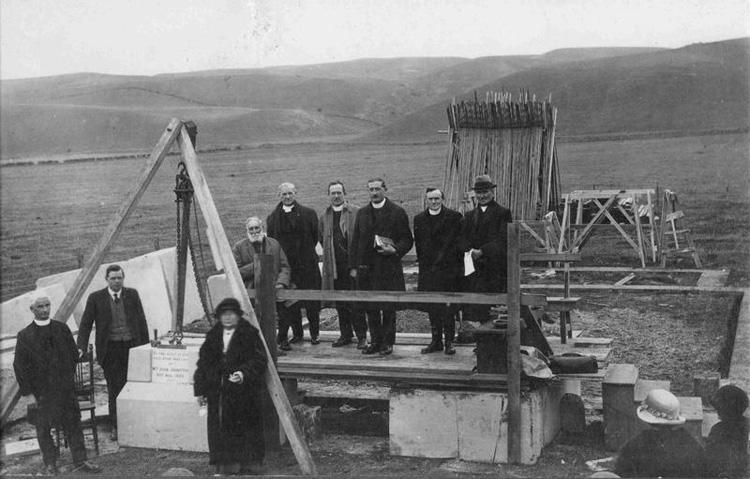 The first stone being laid by Mrs John Johnston in 1925. Photo courtesy collection.culturewaitaki.org.nz